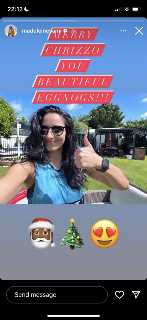 Madeleine Sami gives a thumbs up outside, wearing sunglasses. Text says: "Merry Chrizzo you beautiful eggnogs!" with emoji underneath: "🎅🏾🎄😍"