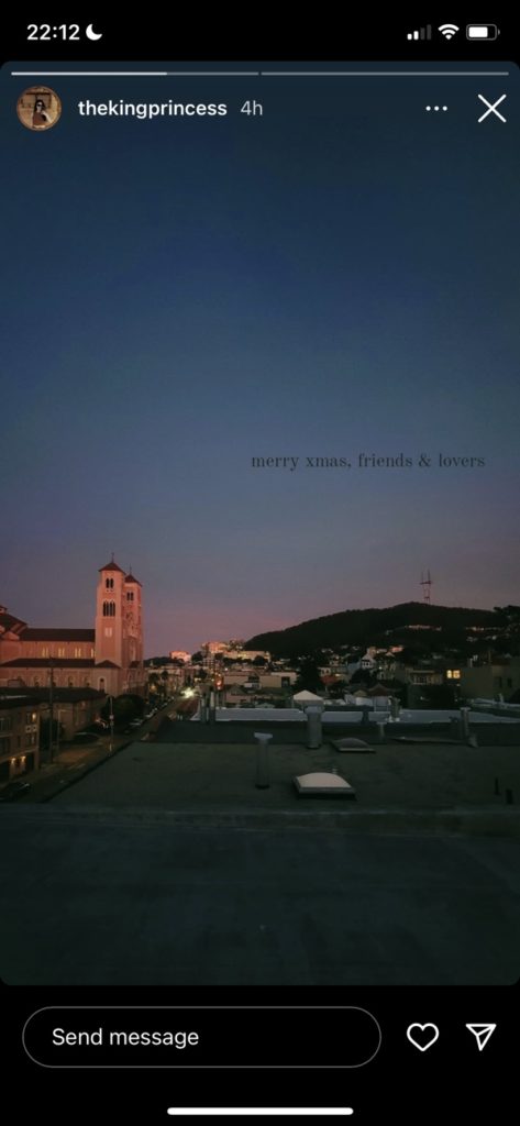 A peaceful sunset photo of some buildings. Text says: "Merry Xmas, friends & lovers"