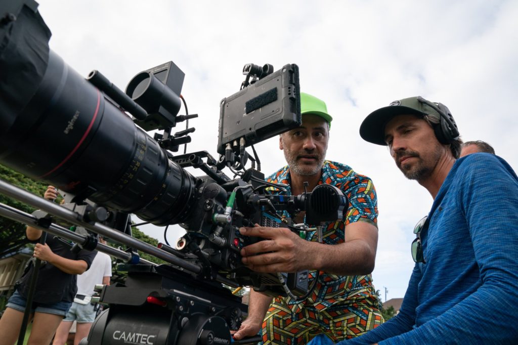 From set of "Next Goal Wins." Taika Waititi is showing a crew member something on the camera.