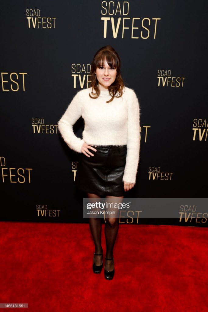 SCAD TVFest 2023. Claudia O'Doherty stands in the press area, posing with a hand on her hip.